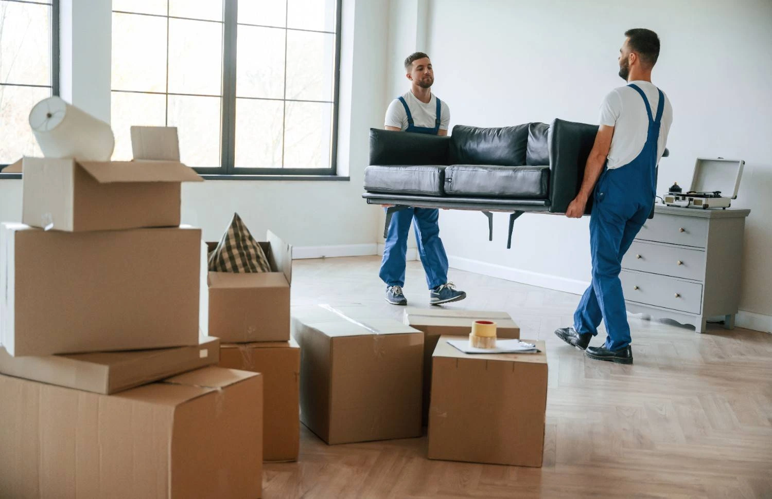 holding-heavy-sofa-two-moving-service-employees-room (1)